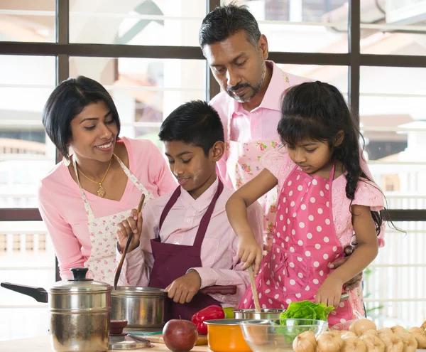 Indian family cooking together in the kitchen