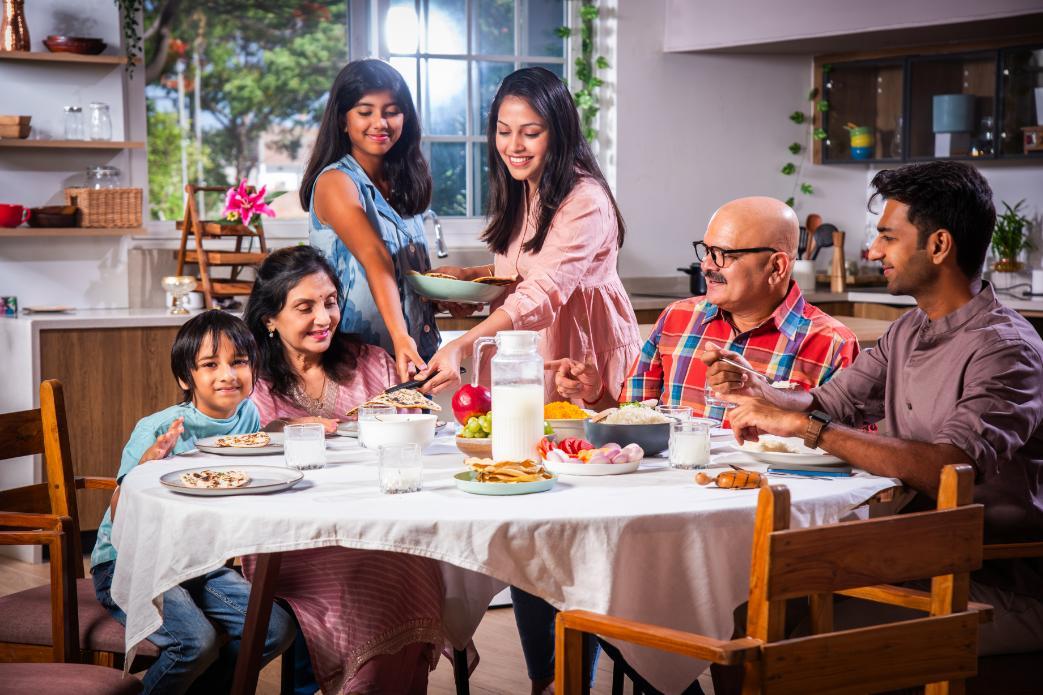 Indian joint family sharing a home-cooked vegetarian dinner